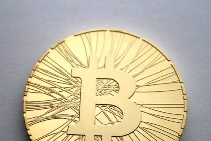 Physical Bitcoin coin — BTC holds near $82,500 ahead of record $11.7B options expiry on October 30