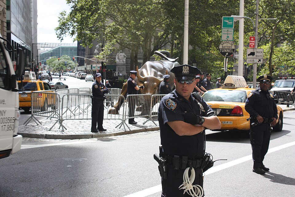 The Charging Bull statue on Wall Street — spot bitcoin ETF assets reached $104.88 billion, about 6.41% of bitcoin's market value