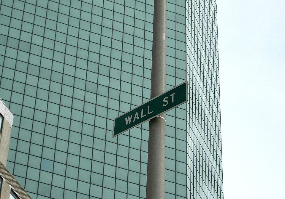 A Wall Street street sign in New York — U.S. spot Bitcoin ETFs posted a second straight day of outflows on Friday